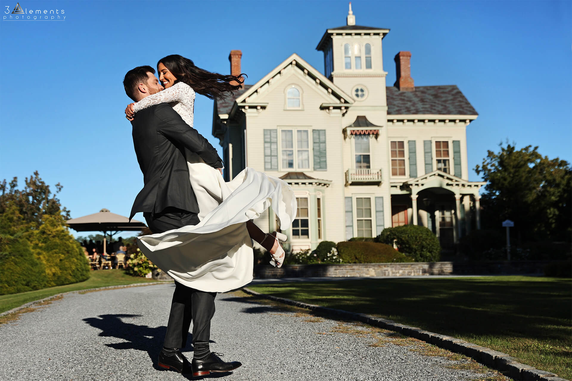 Bride jumping on the Groom in front of Jedediah Hawkins Inn - 3 Elements Photography